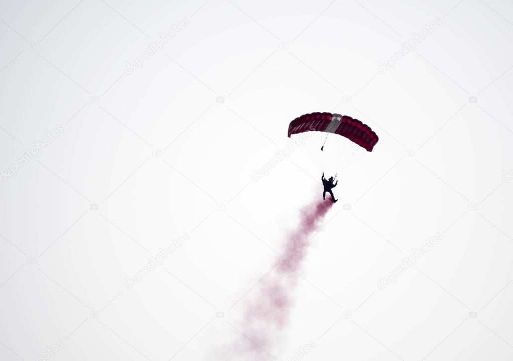 silhouette parachute stunt unfocused and blurry while gliding in