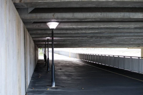 Under the bridge tunnel with light post — 스톡 사진