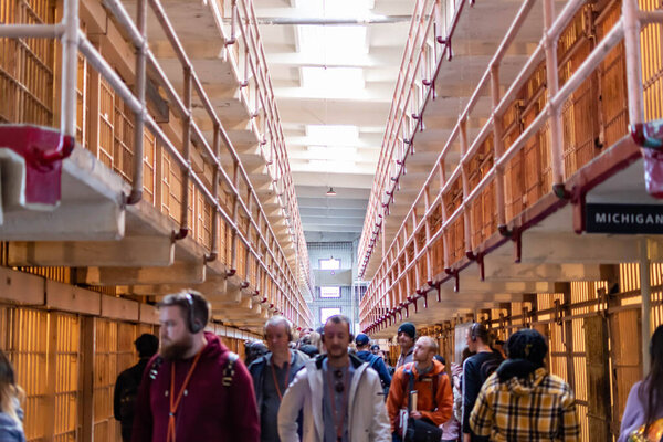 Alcatraz Prison B Block Prisoners cell area and some tourist and visitors inside the cellhouse building, San Francisco California USA, March 30, 2020