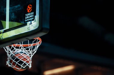 Berlin, Germany, December 18, 2019:official game ball inside the basket during the Euroleague basketball match between Alba Berlin and FC Bayern Munich at Mercedes Benz Arena clipart