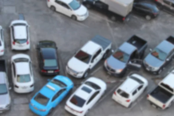 Niewyraźne odkryty parking pełne samochodów: dla transportu ba — Zdjęcie stockowe