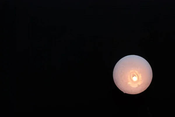 White candle on a black background,