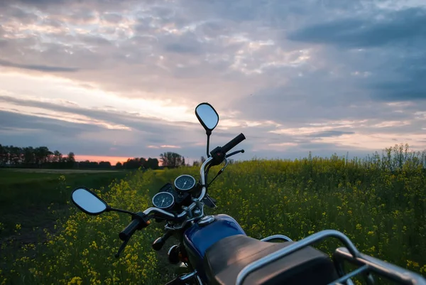 Motorcycle at sunset, rapeseed field, — Stock Photo, Image