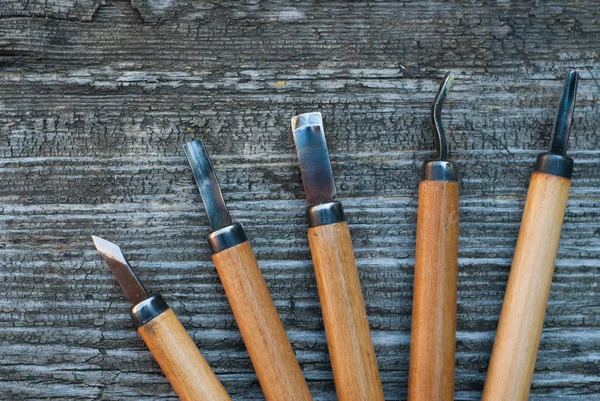 Gereedschap voor hout snijwerk op een oude houten achtergrond — Stockfoto