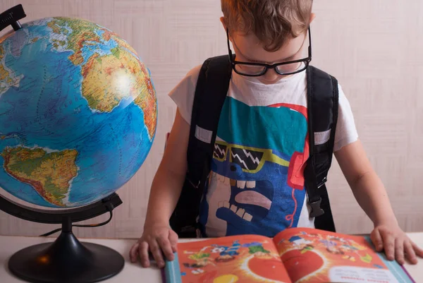 Happy young schoolboy at his Desk in class , — Stock Photo, Image