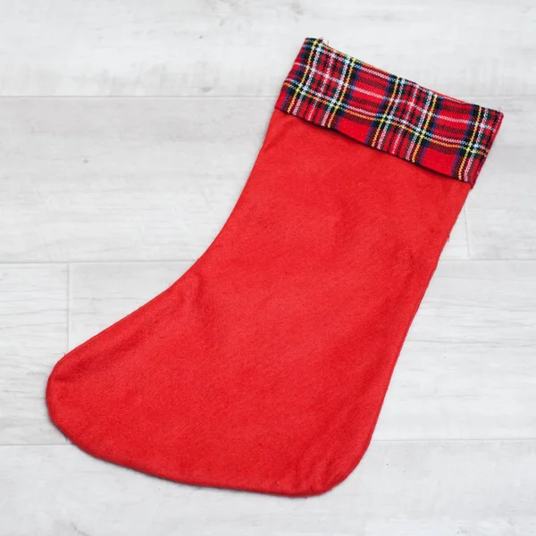 Christmas stocking is lying on a wooden background, — Stock Photo, Image