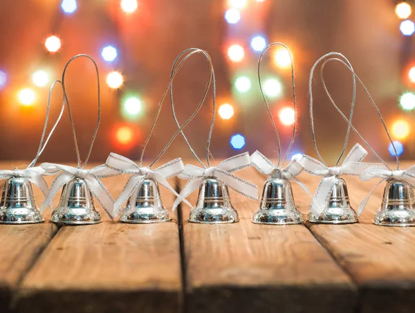 Christmas bells on bright bokeh background,