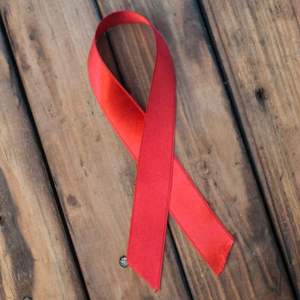 Red ribbon on wooden background, — Stock Photo, Image