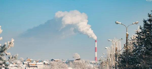 冬の青空を背景に工業用パイプからモーク — ストック写真