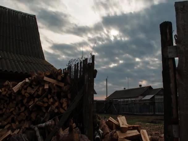 Sunset over rural yard, stab firewood closeup, — Stock Video