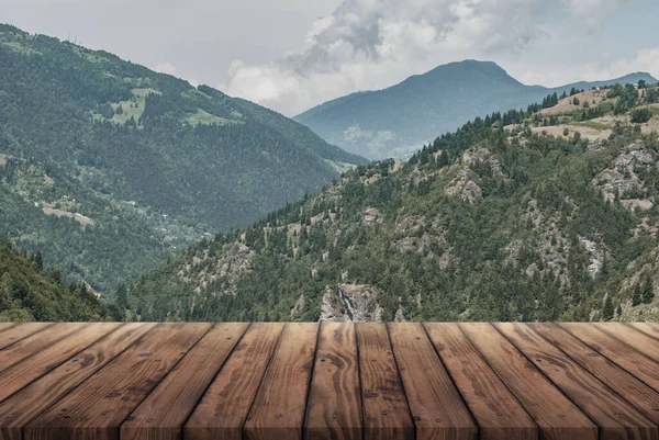 wooden table for advertising with the Alpine mountains in the background