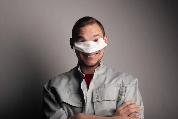 Funny guy mischievous in a medical mask, — Stock Photo, Image
