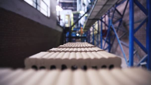 Rows of grey cement bricks are moving on a plant line, close up view — Stock Video