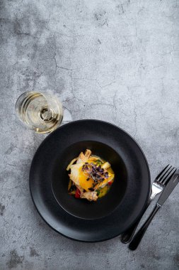 Yaratıcı bir şefin özel yemeği olarak mini sebzeli ve mango soslu kızarmış halibut.