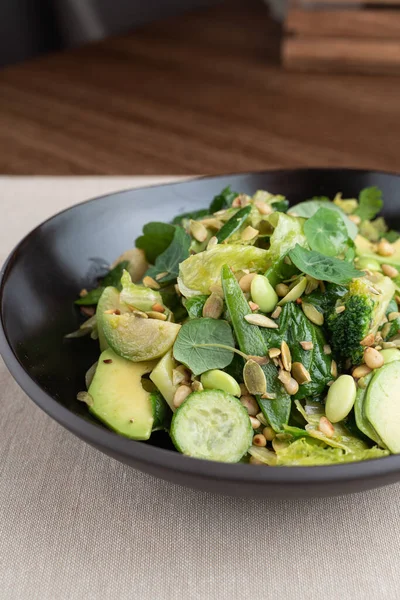 Green edamame salad with sprouts, avocado and cucumber, close up