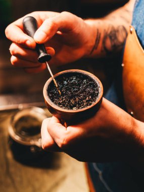 Shisha-man nargile tütünü hazırlıyor. Kil kasesine şiş dolduruyor.