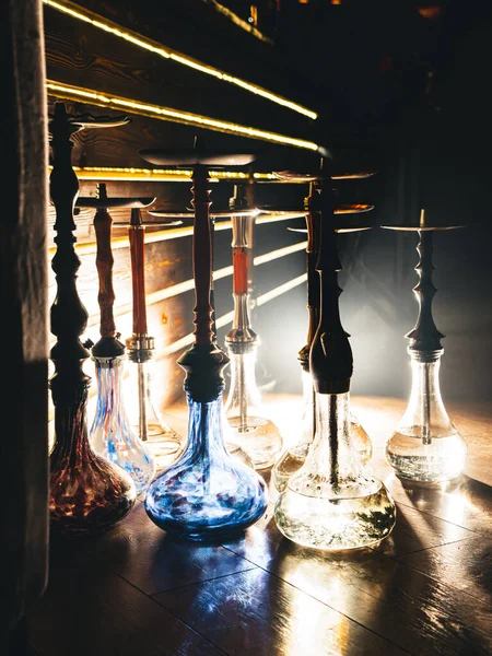 Row of different hookahs in a staff-room in a dramatic light