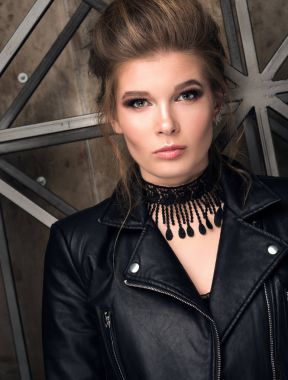 Dikey şık bir genç kadının portresi. Siyah deri ceket ve siyah dekorasyon boyun