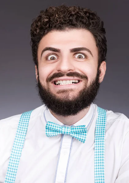 Portrait of stylish young man with a crazy smile. Curly dark hair, beard and mustache — Stock Photo, Image