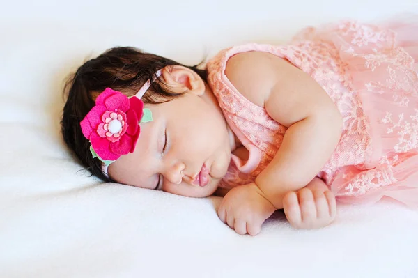 Close-up linda menina adormecida. Recém-nascido, a dormir num cobertor. retrato de, idade 2 meses. vestindo grande, tecido rosa headband. Fechar foto — Fotografia de Stock