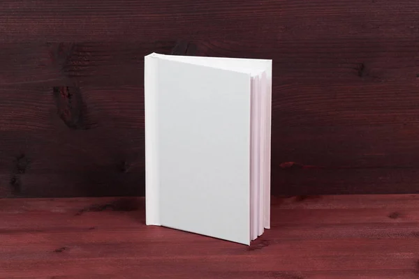 Blank clean white book on wooden table background