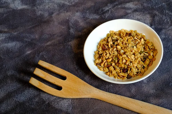 Kepekli Yulaf ve Kurutulmuş Çilek ile mısır gevreği kahvaltısı. Kahvaltı için lezzetli ve mükemmel, sağlıklı bir aperatif, egzersiz yemeği ya da dondurma malzemesi olarak. Üst manzara, düz uzanma.