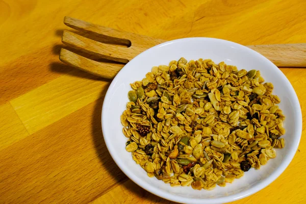 Kepekli Yulaf ve Kurutulmuş Çilek ile mısır gevreği kahvaltısı. Kahvaltı için lezzetli ve mükemmel, sağlıklı bir aperatif, egzersiz yemeği ya da dondurma malzemesi olarak. Üst manzara, düz uzanma.