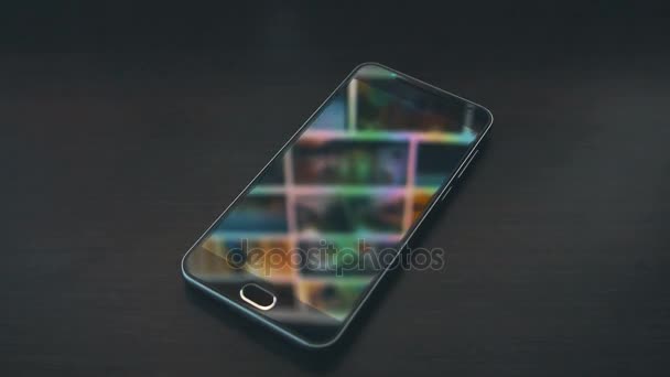 Smartphone with scrolling gallery page monitor reflections on the background. Down sliding. — Stock Video