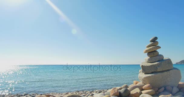 波石のビーチに着陸します。瞑想、石ピラミデ。澄んだ青い水. — ストック動画