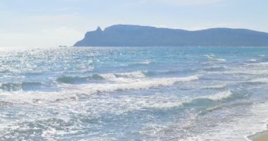 Dalgalar kumsalda iniş. Açık mavi su