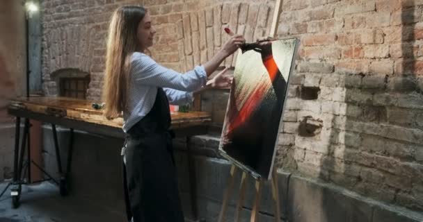 Talented innovative pretty Female Artist Draws with brush on the Canvas. Contemporary young woman painter creating abstract picture. Attractive girl creates modern art painting — Stock Video