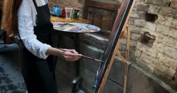 Talented innovative pretty Female Artist Draws with brush on the Canvas. Contemporary young woman painter creating abstract picture. Attractive girl creates modern art painting — 비디오