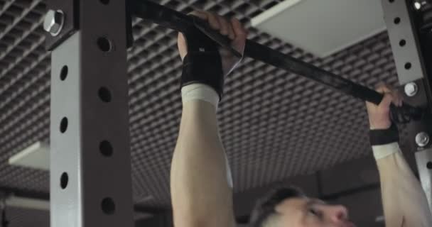 Training pull ups, intense strength exercise in closed gym. Men doing pull ups workout — Stock Video