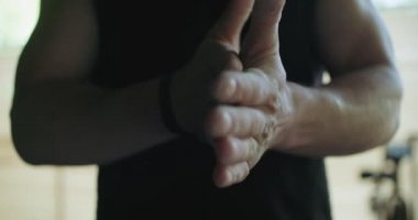 Atletler el kaldırmaya hazırlanıyor. Egzersizden önce karanlık bir odada el sıkışmak.