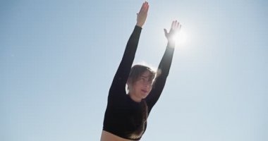 Genç sarışın kadın göldeki ahşap ranzada yoga yapıyor. Güneşli havalarda tek spor doğa üzerine sağlıklı eğitim