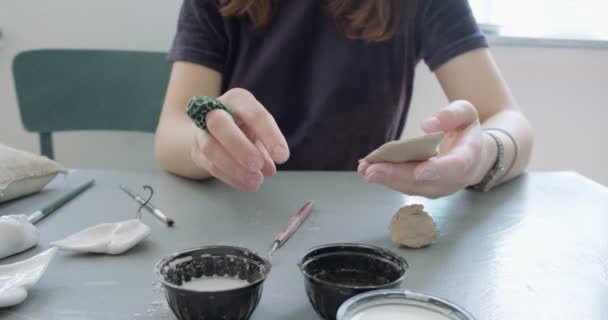 Woman making doll ceramic part. Female sitting and creating ear for doll at home at table. Pottery dolls parts, handmade and creative skills — Stock Video