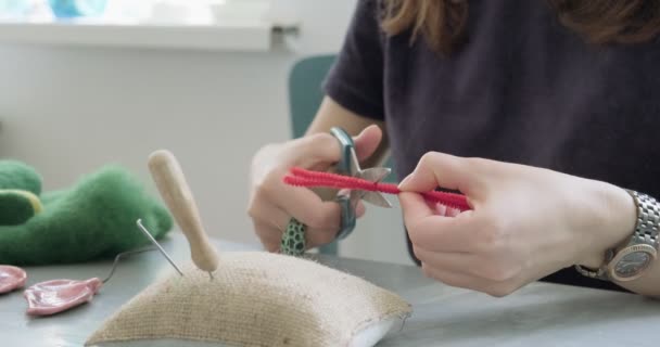 Woman making wool art doll toy at table close up. Female sitting and creating ooak doll at home. Needle Felted Handmade and creative skills — Stock Video