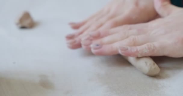 Alfarera sentada y haciendo una taza en la mesa. Mujer haciendo artículo de cerámica. Trabajo de cerámica, habilidades hechas a mano y creativas — Vídeo de stock