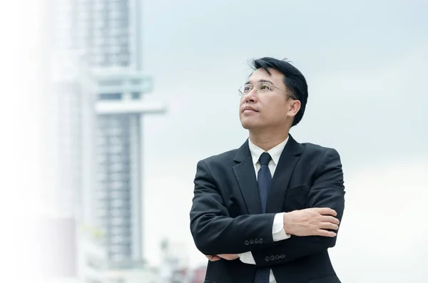 Portrait of businessman with arms crossed standing. Stock Picture