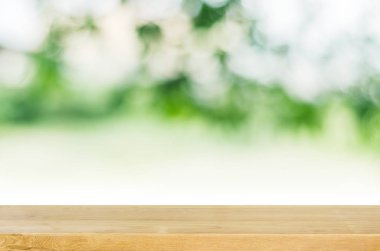 Ahşap masa üstü yeşil bahçe arka plan bulanık ile boş.
