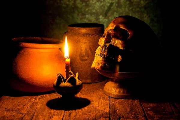 Skull and candle with candlestick on wooden background, still life concept — Stock Photo, Image