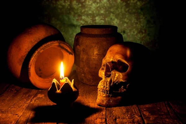 Skull and candle with candlestick on wooden background, still life concept — Stock Photo, Image