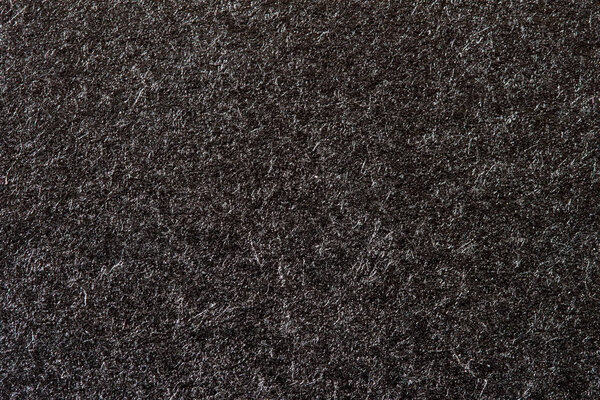 Texture of organic black paper for artwork with numerous natural inclusions. Modern dark background, backdrop, substrate, composition use with copy space