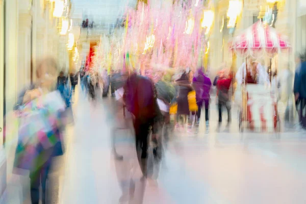 Abstract defocused motion blurred People in bright clothes walking in the shopping center, urban lifestyle concept. For background , backdrop, substrate. Spring sales