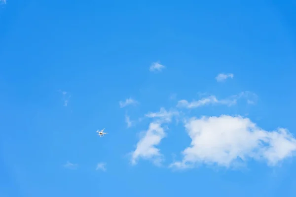 Flying drone leaving high on blue sky with clouds, texture. For modern background, pattern, wallpaper or banner design with place for text — Stock Photo, Image