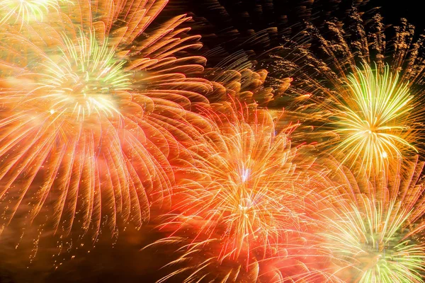 Beautiful firework as golden chrysanthemum, spherical break of colored stars, similar to a peony, but with stars that leave a visible trail of sparks. — Stock Photo, Image