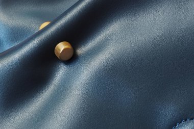 Detail of womens leather handbag of blue color, matte golden decor, texture clipart