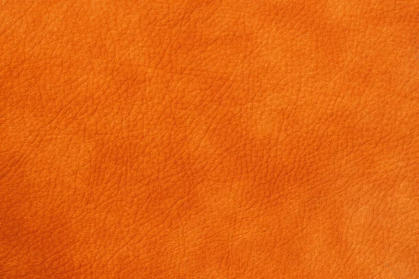 Texture of genuine leather close-up, cowhide, orange. For natural, artisan backgrounds, substrate composition use, vintage design — Stock Photo, Image