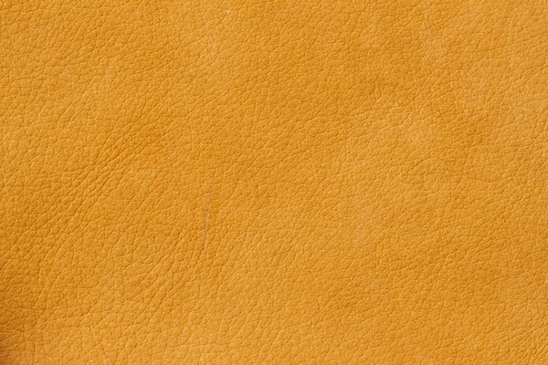 Textura de cuero genuino de cerca, piel de vaca. Color naranja soleado. Para fondos naturales, artesanales, uso de composición de sustrato, diseño vintage — Foto de Stock