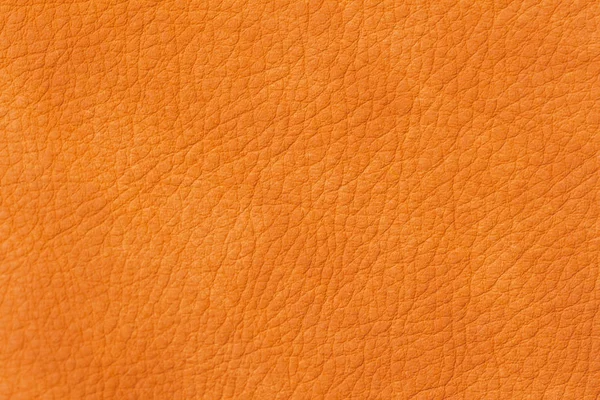 Texture of genuine leather close-up, cowhide, orange. For natural, artisan backgrounds, backdrop, substrate composition use — Stock Photo, Image